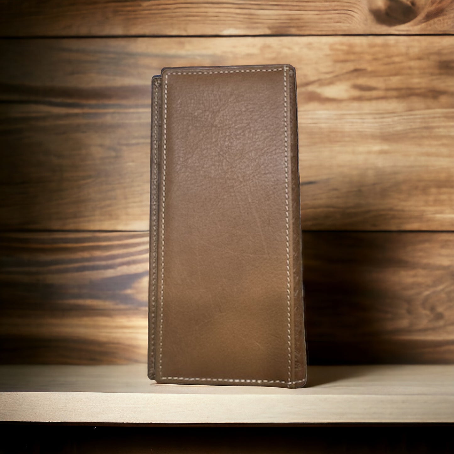 A Bull Rider Long Wallet W Cowhair Basketweave by Western Stakes, a perfect cowboy accessory, stands upright on a wooden shelf with a wood-paneled background. The wallet has a textured surface and visible stitching along the edges, giving it a rugged yet refined appearance.