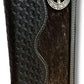 A Longhorn Long Wallet Black With Cowhair Basketweave by Western Stakes with a cowhair basketweave design along the left side and smooth leather on the right, featuring a silver decorative emblem with a stag head and intricate detailing on the upper right corner.