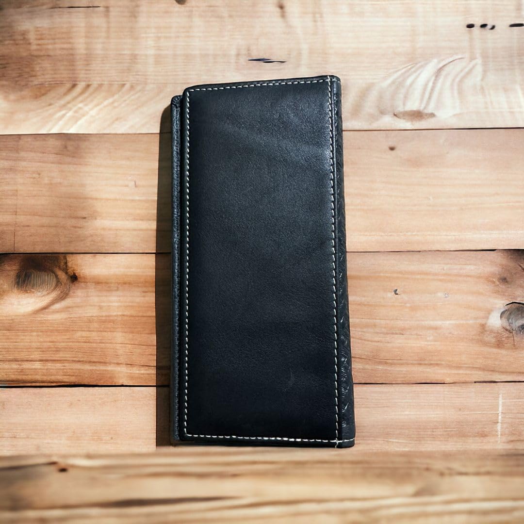 A Longhorn Long Wallet Black With Cowhair Basketweave by Western Stakes is placed on a wooden surface. The wallet is closed and centered in the image, showcasing its sleek, minimalist aesthetic. The wood grain of the surface adds a rustic background.