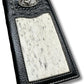 A Western Stakes Rodeo Long Wallet Black With Cowhair & Bull Rider Concho. This cowboy wallet includes a decorative metal emblem near the top, featuring an intricate design. The leather has a textured finish with visible stitching along the borders.