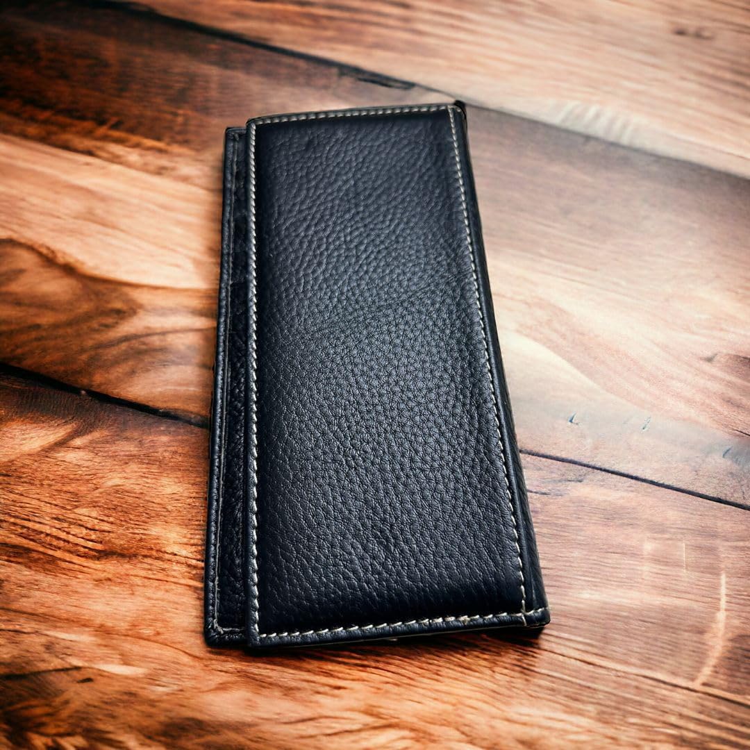 A Rodeo Long Wallet Black With Cowhair & Bull Rider Concho by Western Stakes, reminiscent of a fashionable cowboy wallet, rests on a polished wooden surface. The wallet is closed, showcasing its textured material and sleek design. The lighting highlights the grain of the wood and the texture of the leather.