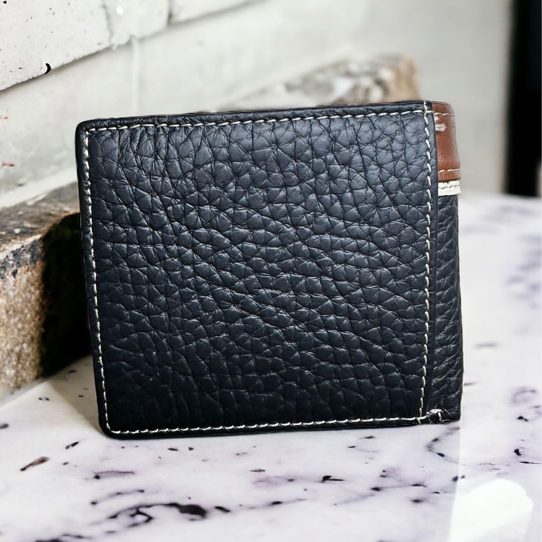 The image shows a **Mens Leather Wallet Horse & Horseshoe Soft Black Leather Bi Fold** with white stitching placed on a marble surface. The **Western Stakes** wallet has a textured finish and a hint of brown leather visible at the top corner, featuring an engraved horse design. A brick wall serves as the background.