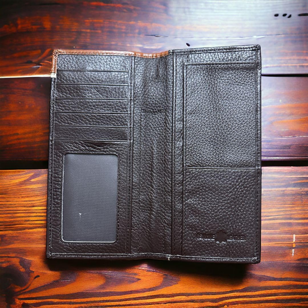 A Western Stakes Mens Leather Long Wallet Longhorn Horseshoe Coffee, featuring multiple card slots, a clear ID window, and various compartments, is open and laid flat on a wooden surface. The texture of the leather is visible, adorned with fine stitching details and a distinctive longhorn horseshoe concho.