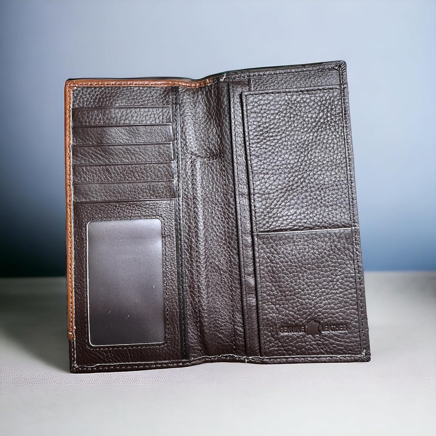 An open Floral Long Wallet Coffee Star Concho by Western Stakes displayed upright on a surface against a plain, gradient background. The men's wallet features multiple card slots, a clear ID window, and large compartments for cash or other items. With its textured finish in dark brown, it's the perfect gift for him.